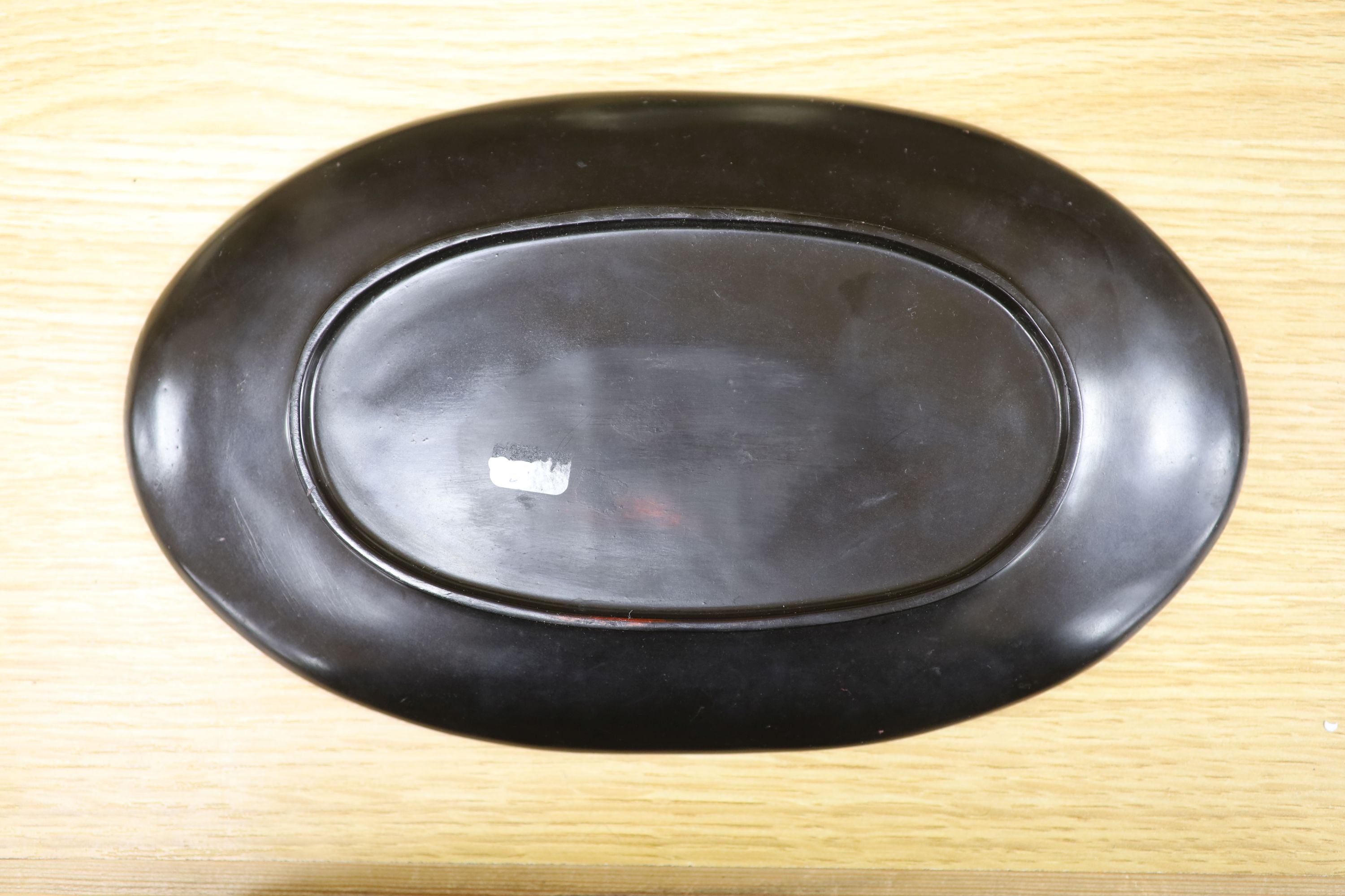 A Chinese lacquer and composition dish and a bronze hand warmer, length 27cm